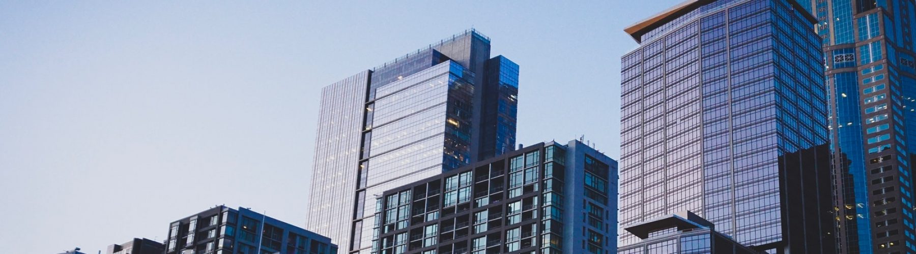 white and blue glass walled high rise building